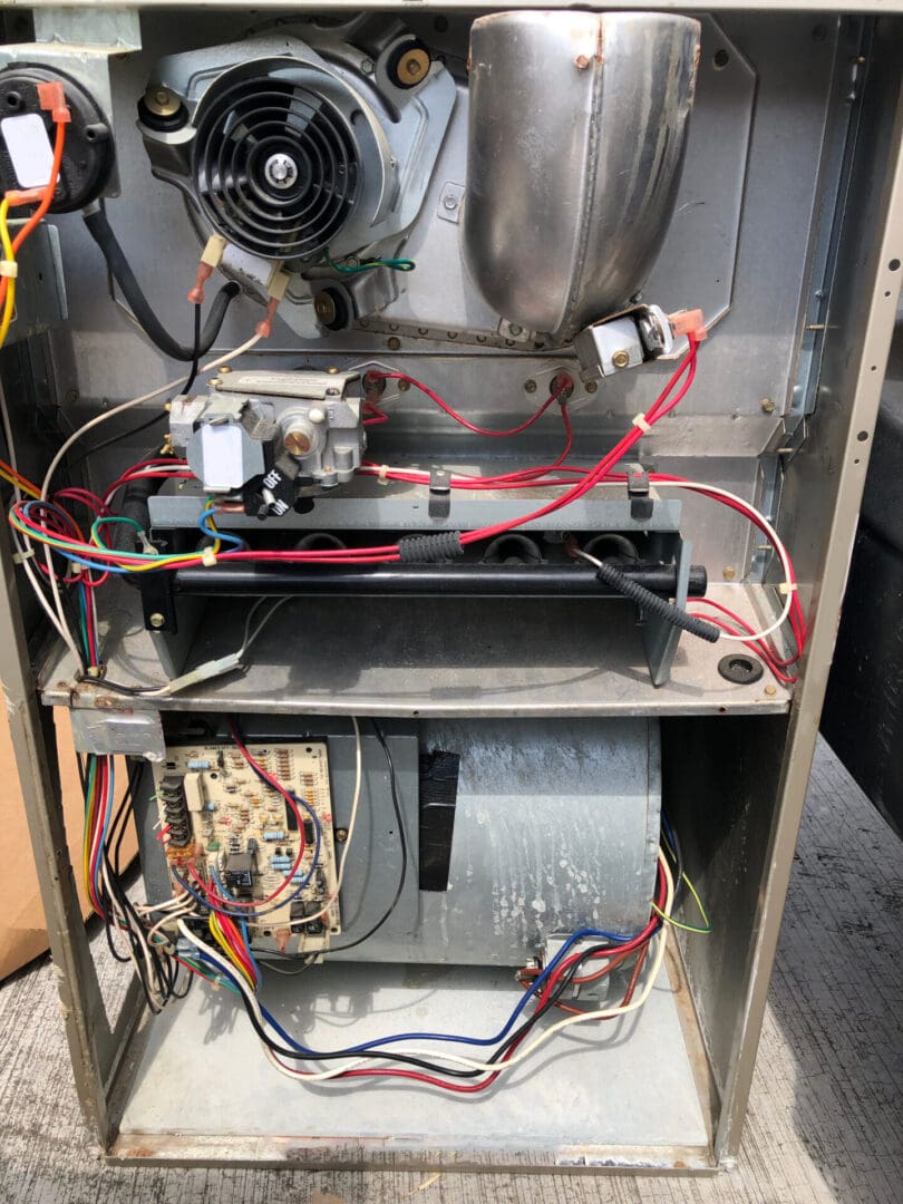 Open furnace with exposed wiring and components.